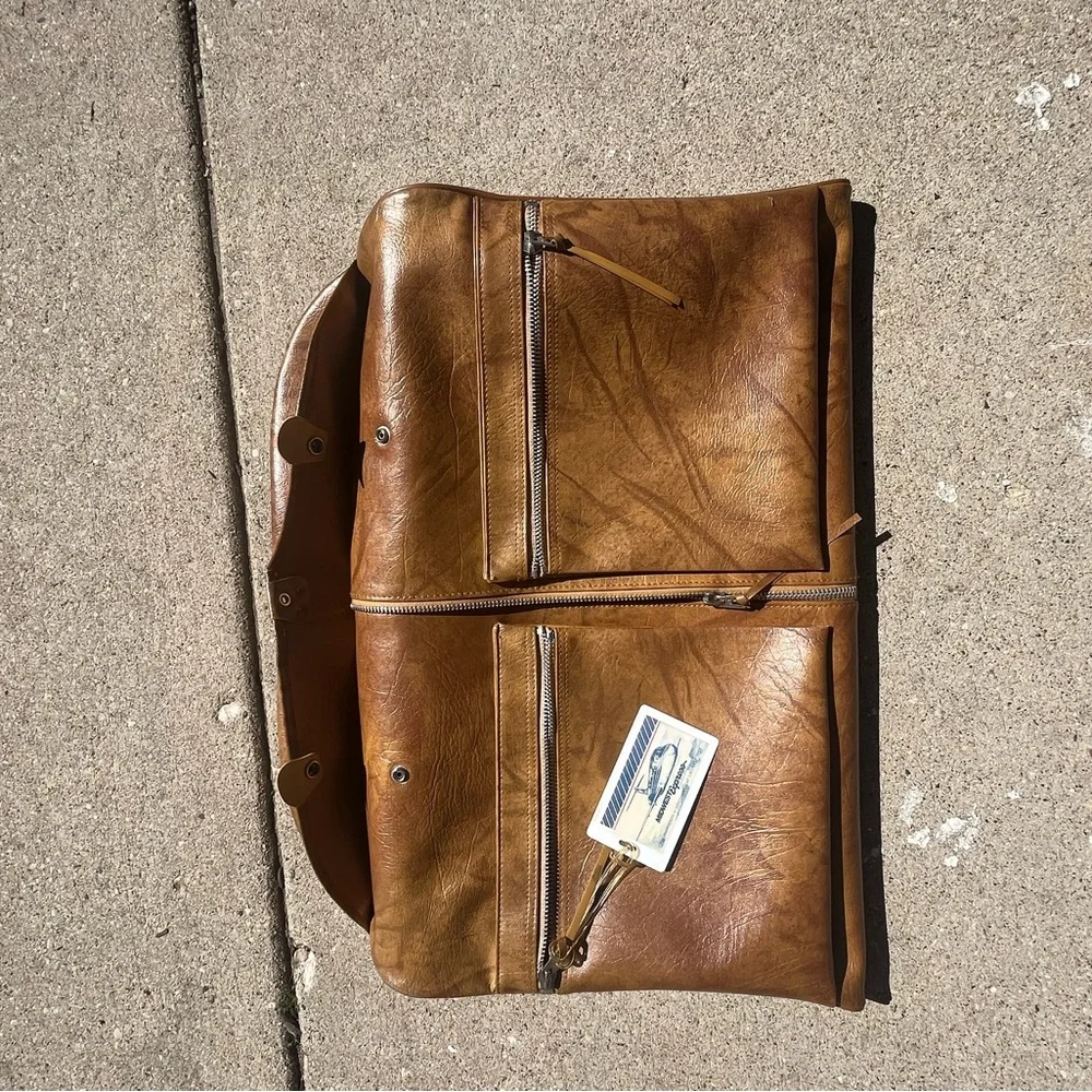 Vintage leather carry on for hanging clothes.